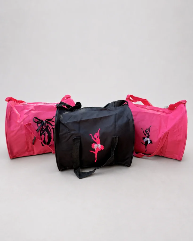 Pink and black dance bags featuring ballerina designs on a light studio background.