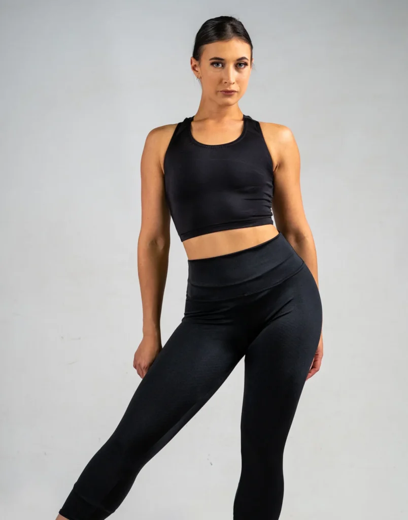 Dancer wearing black cropped leggings and a matching crop top.